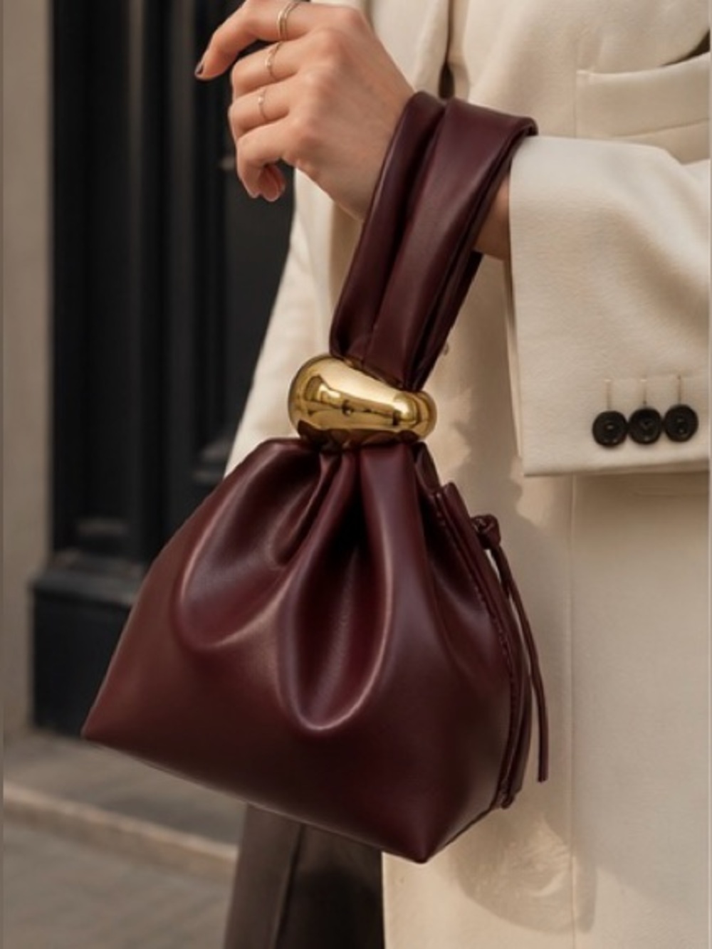 Sculptural Burgundy Leather Mini Bag with Signature Gold Knot